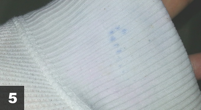 Step five. Cleaning a paint stain on a shirt.